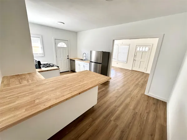 a living room with hard wood floors and a fireplace