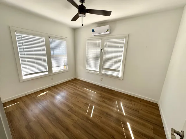 a bathroom with a sink a toilet a mirror and bathtub