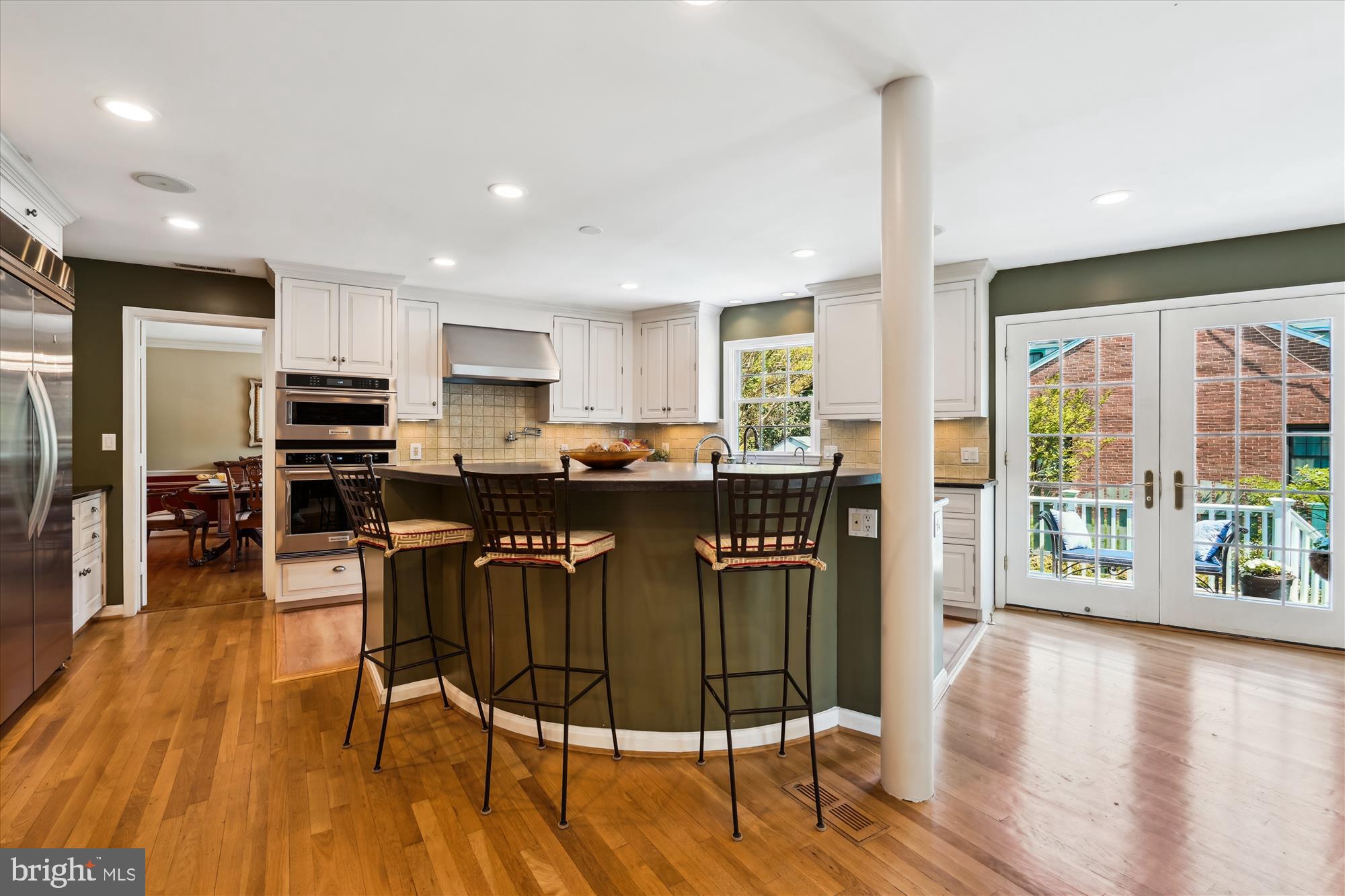 7101 Old Gate Road Rockville, MD 20852 - Photo 12 of 52 a living room with stainless steel appliances granite countertop a refrigerator a stove top oven and a dining table with wooden floor