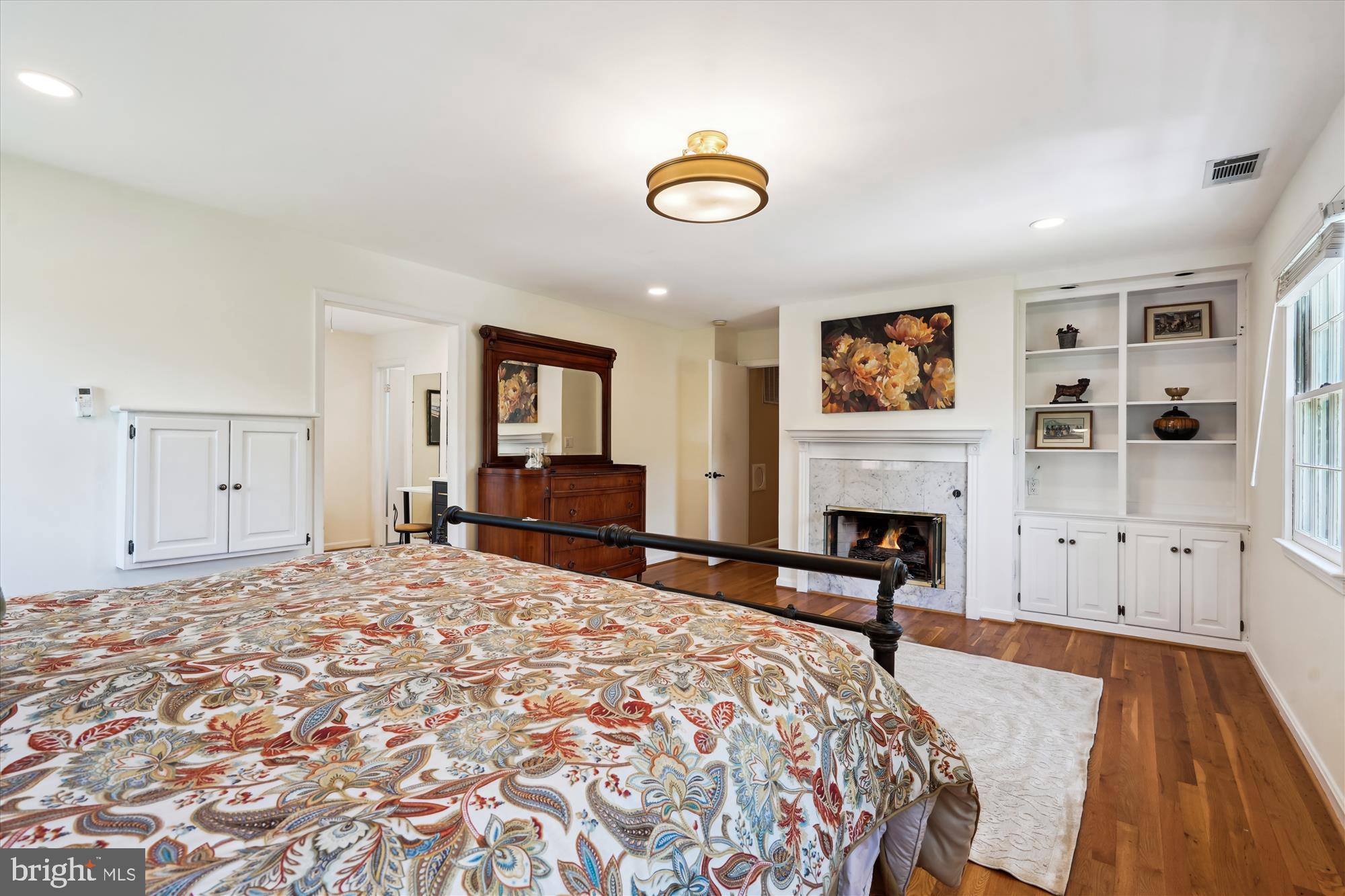 7101 Old Gate Road Rockville, MD 20852 - Photo 24 of 52 a spacious bedroom with a bed and a fireplace