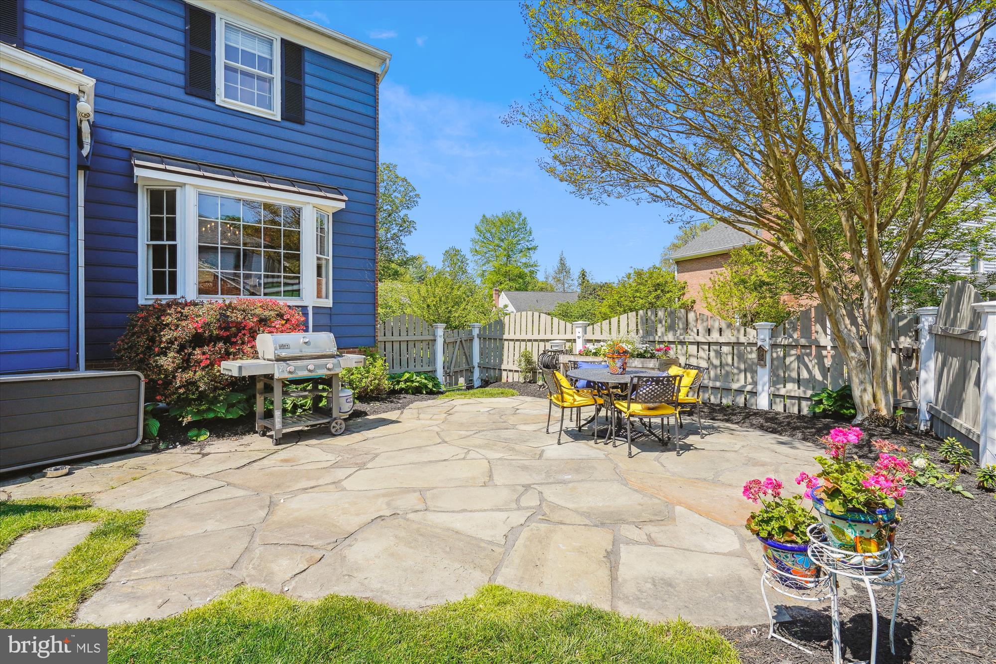 7101 Old Gate Road Rockville, MD 20852 - Photo 45 of 52 a view of a brick house with a bench in a patio
