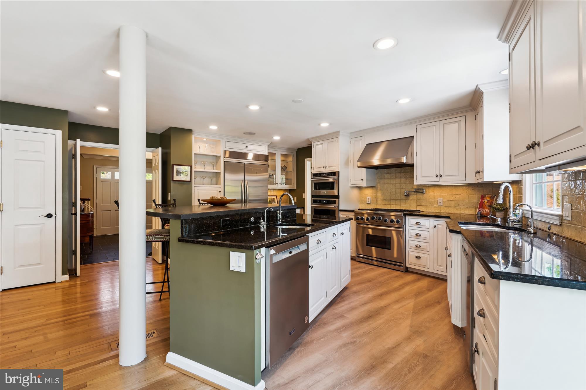 7101 Old Gate Road Rockville, MD 20852 - Photo 10 of 52 a kitchen with stainless steel appliances granite countertop a stove top oven a sink a refrigerator and white cabinets