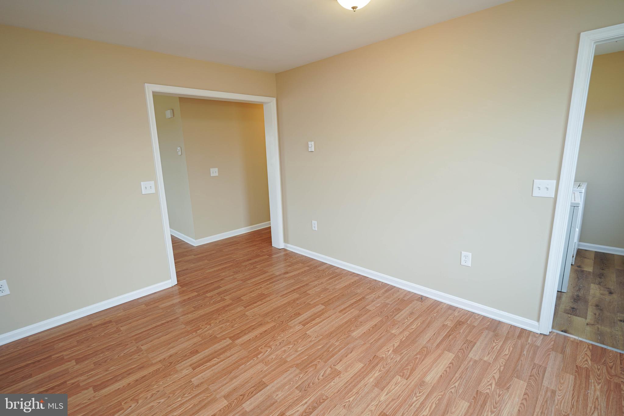 7526 Bethel Road Willards, MD 21874 - Photo 12 of 34 a view of an empty room with wooden floor and a window