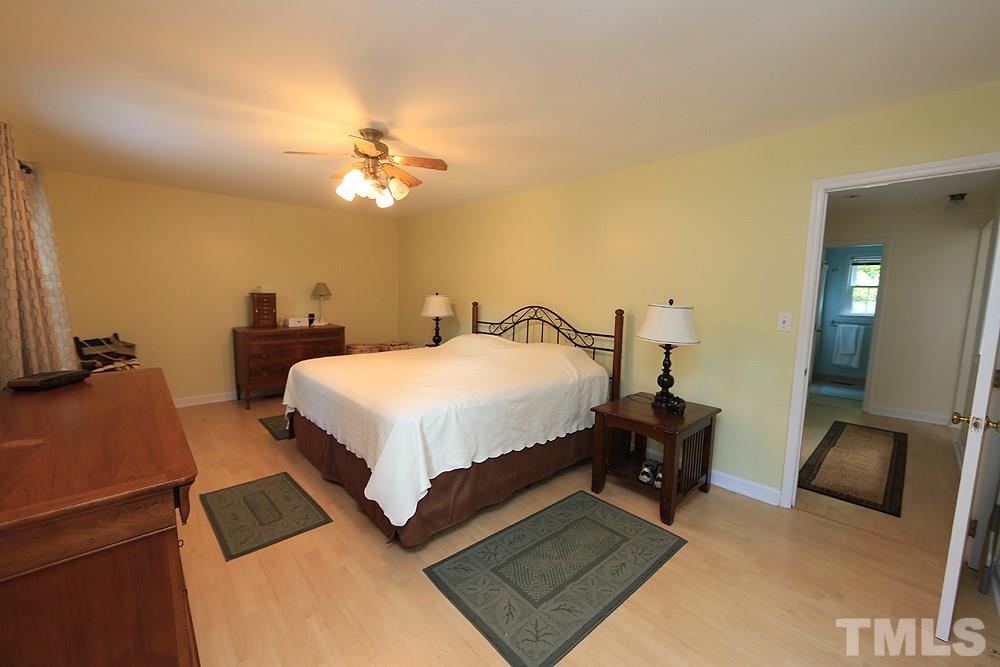 409 Vernon Terrace Raleigh, NC 27609 - Photo 13 of 23 Another Very Spacious Second Floor Bedroom with Laminate Flooring and Ceiling Fan with View of Front Yard.