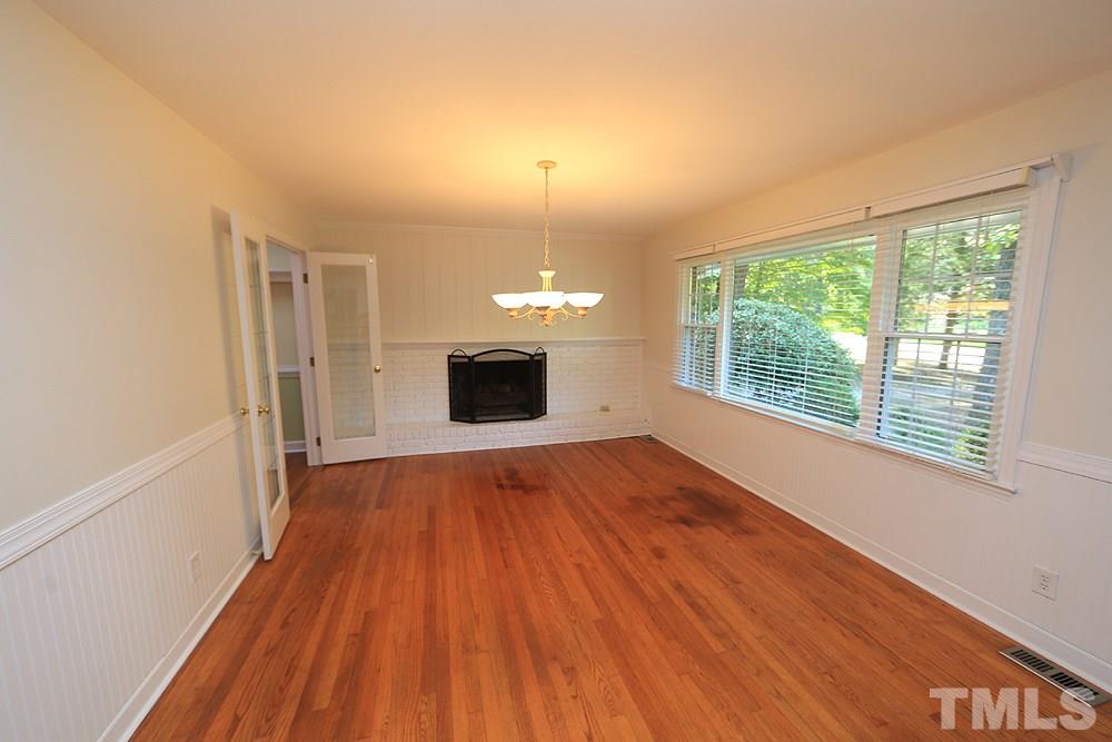 409 Vernon Terrace Raleigh, NC 27609 - Photo 3 of 23 This Room Can be A Formal Living or Dining Room...You Choose. Offers a Triple Window View of the Front Yard, Original Hardwood Floors and a Gas Fireplace.