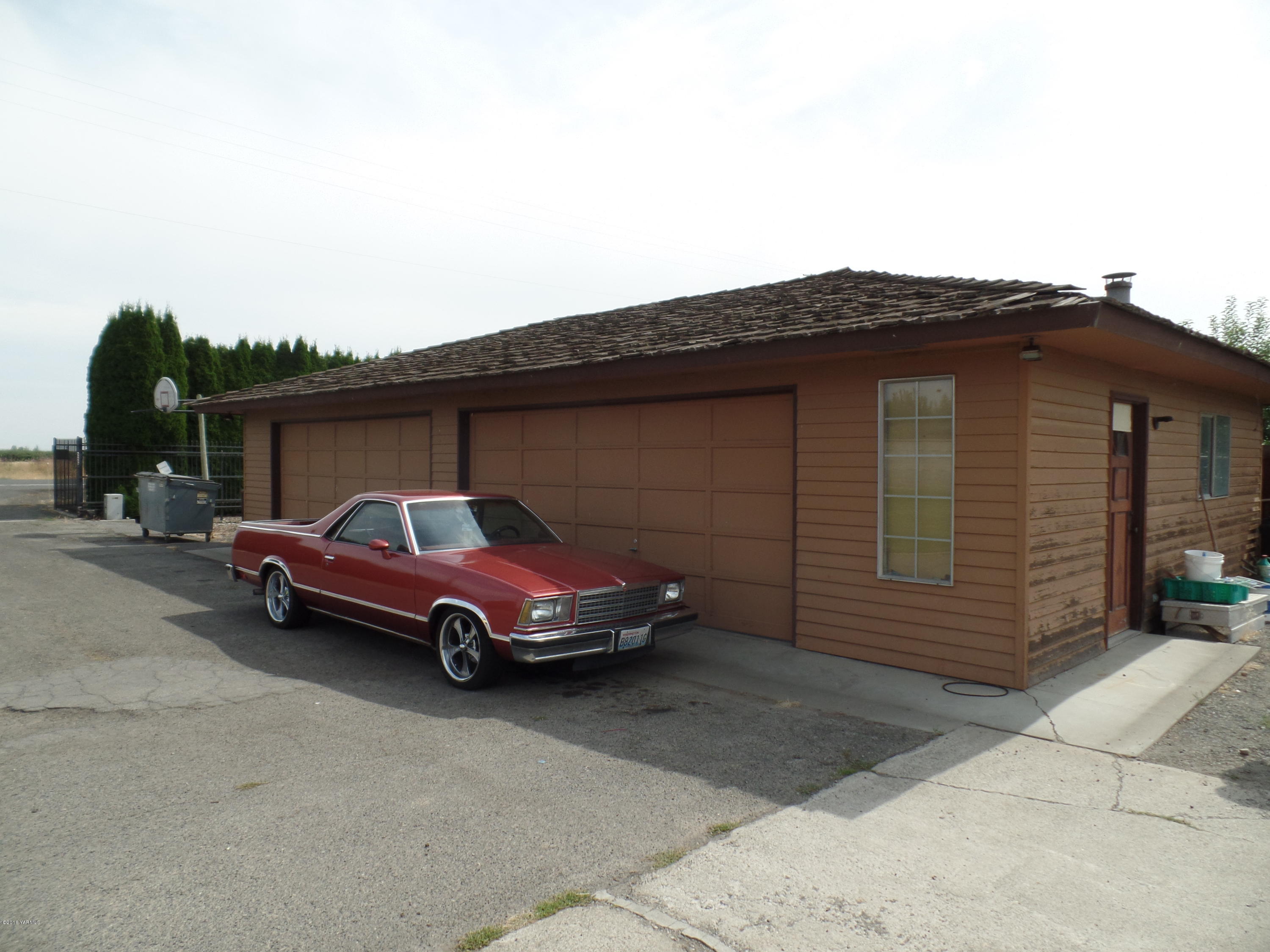 2320 Lateral A Road Wapato, WA 98951 - Photo 5 of 5 a car parked in front of a house
