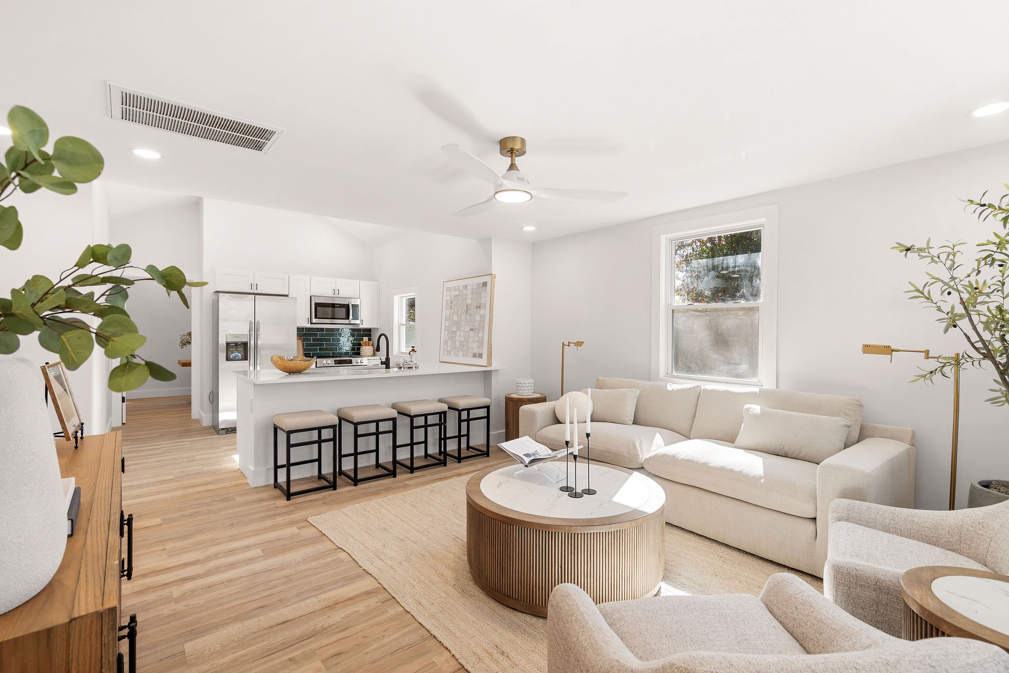 a living room with furniture and a wooden floor