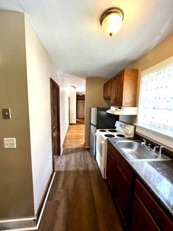 9 Castle Street Ware, MA 01082 - Photo 12 of 19 a kitchen with stainless steel appliances granite countertop a sink stove and refrigerator