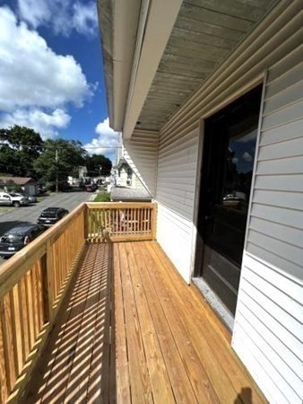 9 Castle Street Ware, MA 01082 - Photo 13 of 19 a view of balcony with wooden floor and stairs