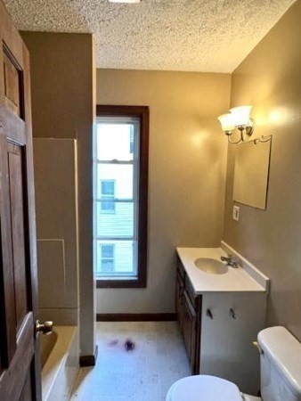 9 Castle Street Ware, MA 01082 - Photo 17 of 19 a bathroom with a sink mirror vanity and toilet