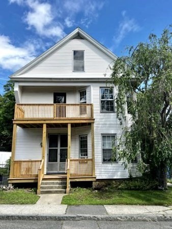 9 Castle Street Ware, MA 01082 - Photo 3 of 19 a front view of a house with a yard