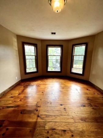 9 Castle Street Ware, MA 01082 - Photo 8 of 19 a view of an empty room with window and wooden floor