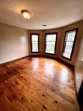 9 Castle Street Ware, MA 01082 - Photo 9 of 19 a view of an empty room with window and wooden floor