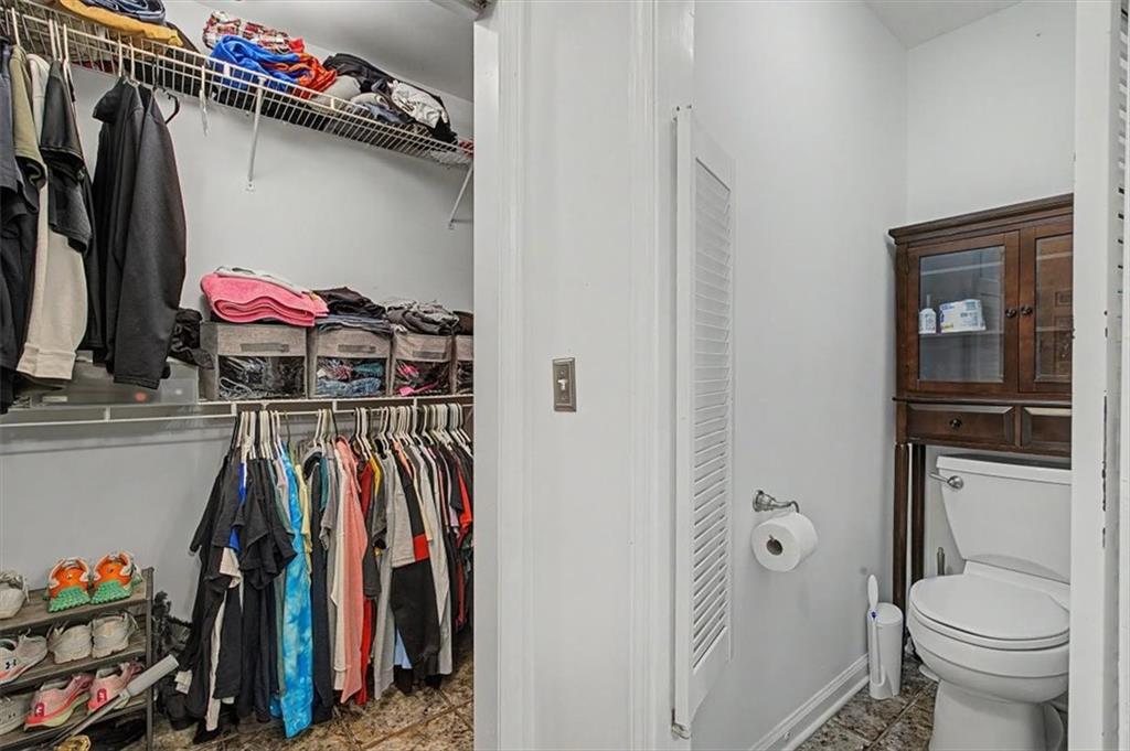 409 Windsor Way Canton, GA 30115 - Photo 31 of 51 a view of walk in closet with clothes