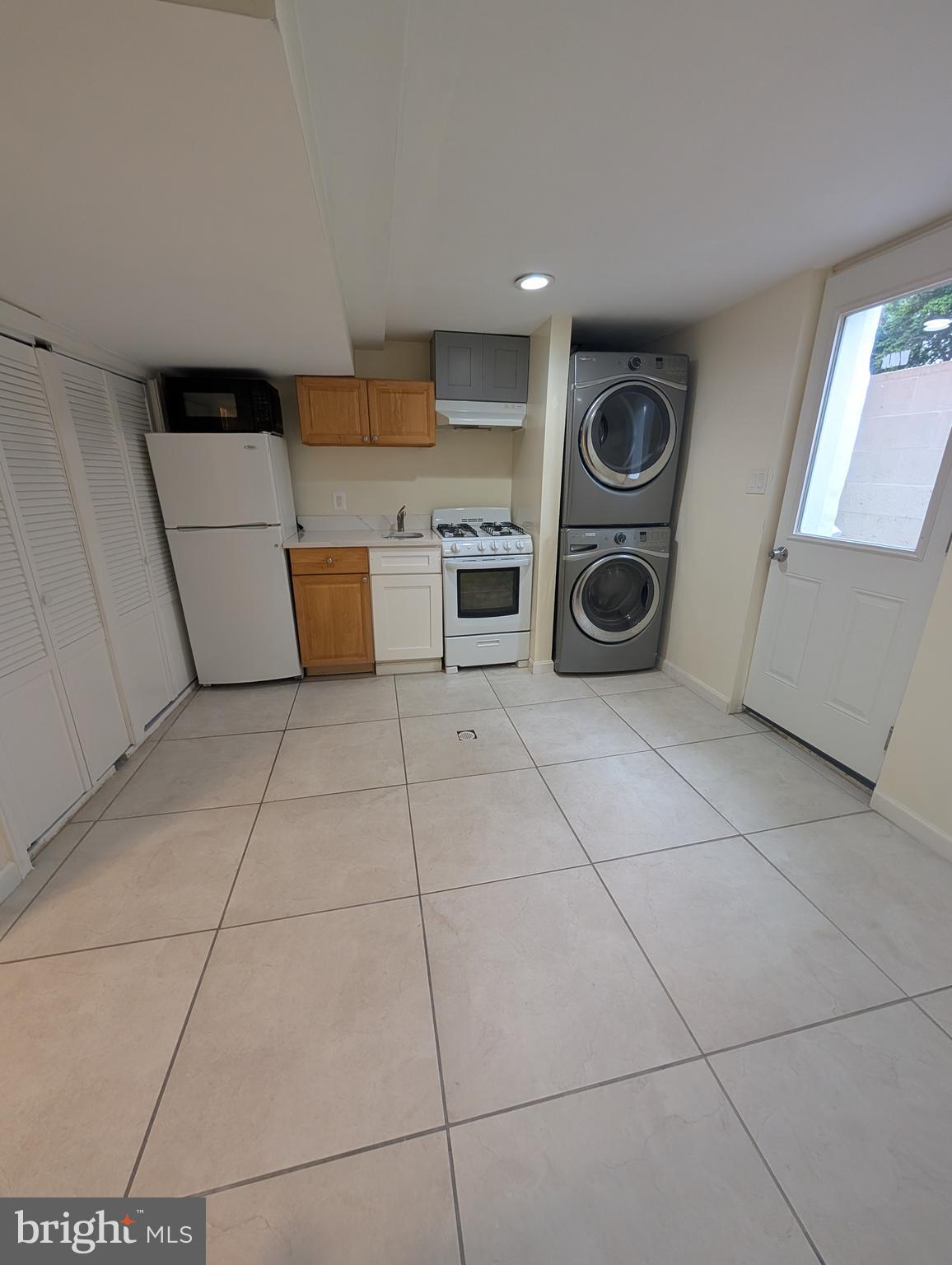 11926 Bluhill Road Silver Spring, MD 20902 - Photo 13 of 27 a utility room with cabinets dryer and washer