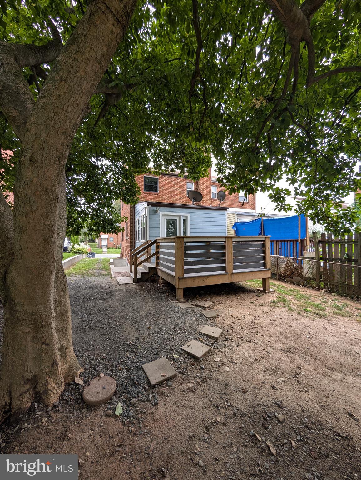 11926 Bluhill Road Silver Spring, MD 20902 - Photo 23 of 27 a view of backyard with large trees and wooden fence