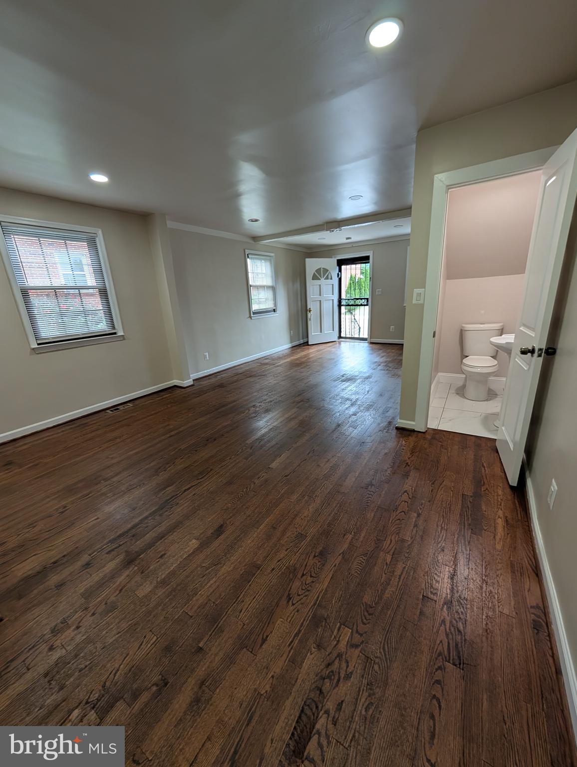 11926 Bluhill Road Silver Spring, MD 20902 - Photo 5 of 27 an empty room with wooden floor and windows