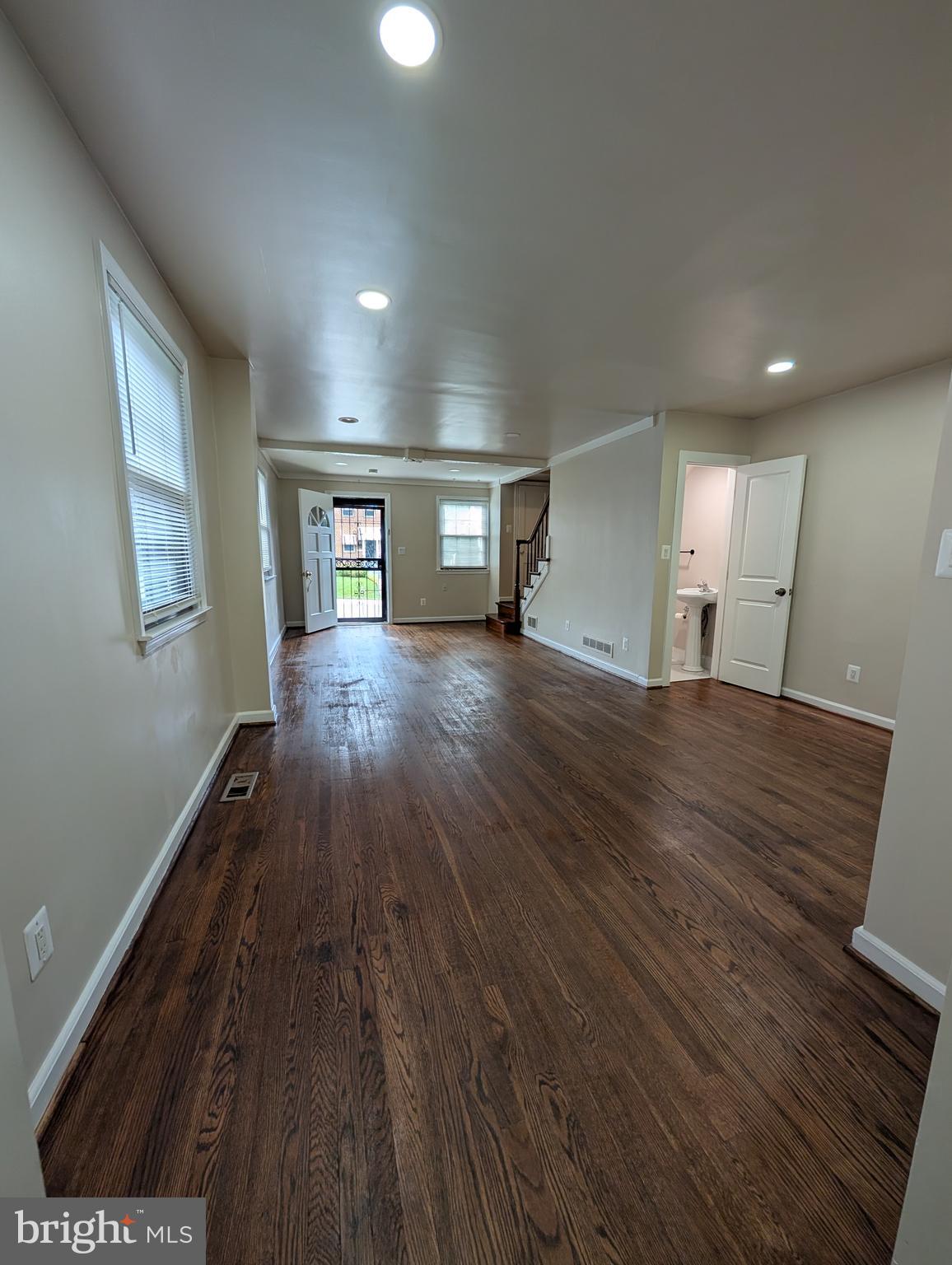 11926 Bluhill Road Silver Spring, MD 20902 - Photo 6 of 27 a view of an empty room with wooden floor and a window