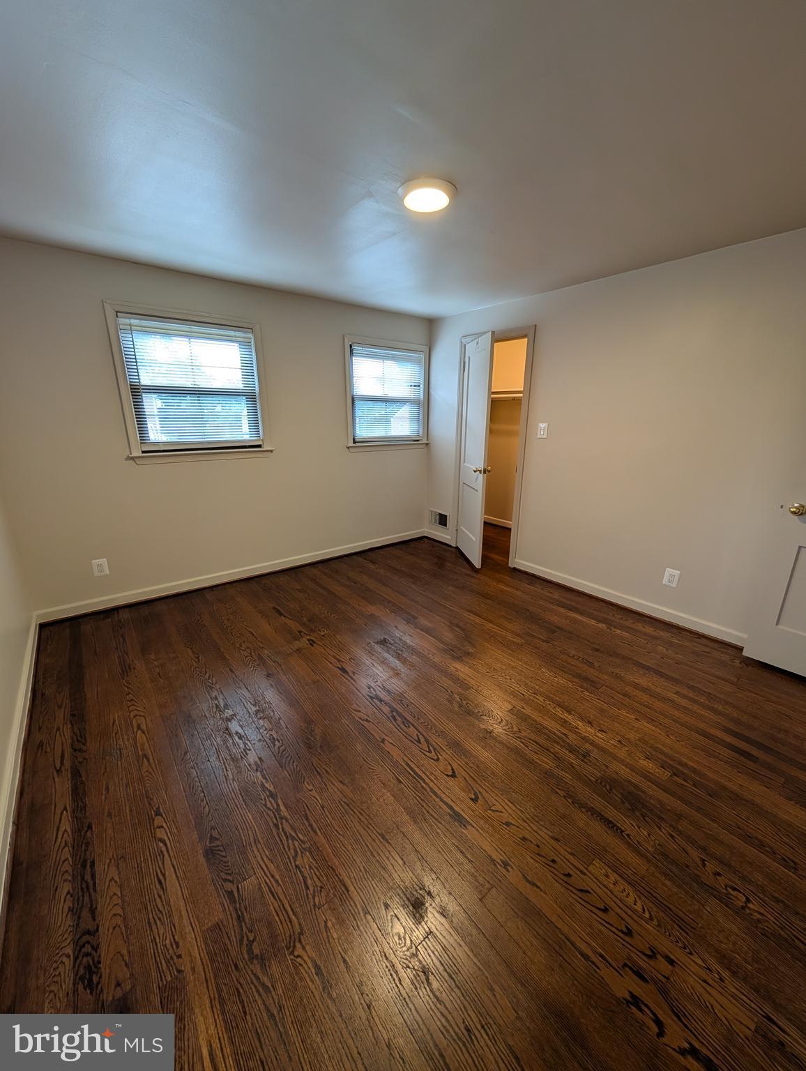 11926 Bluhill Road Silver Spring, MD 20902 - Photo 9 of 27 an empty room with wooden floor and windows