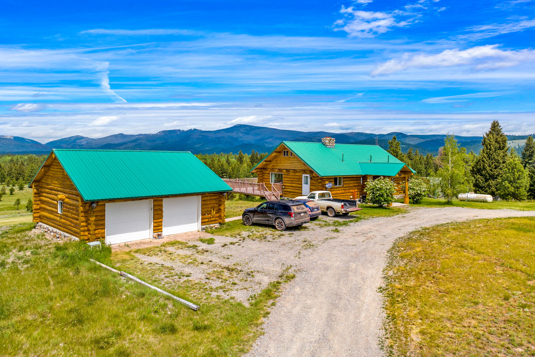 3358 Strandskov Road Lincoln, MT 59639 - Photo 66 of 80 Aerial view of property and surrounding area featuring mountains