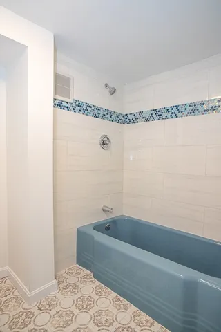 a bathroom with a toilet a sink and a mirror