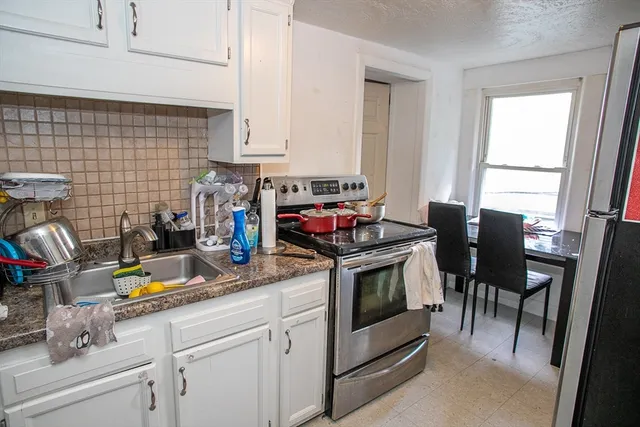 a bedroom with a bed and workspace