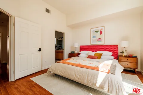 a bedroom with a bed and a mirror
