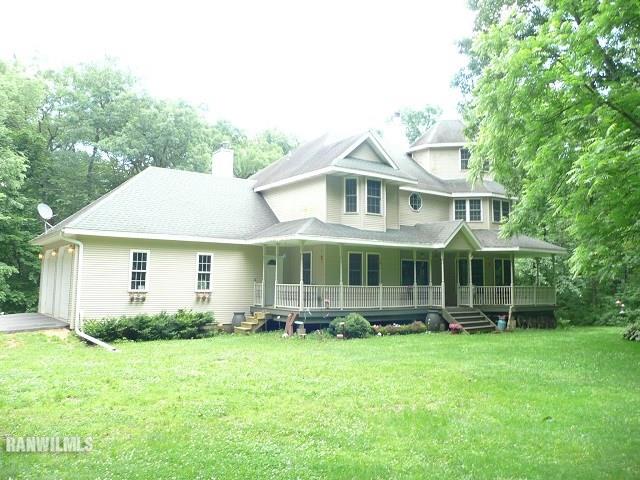 6570 West Cook Road Lena, IL 61048 - Photo 1 of 58 a front view of a house with garden