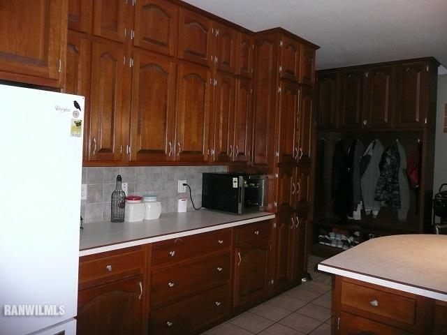 6570 West Cook Road Lena, IL 61048 - Photo 12 of 58 a kitchen with a refrigerator and cabinets