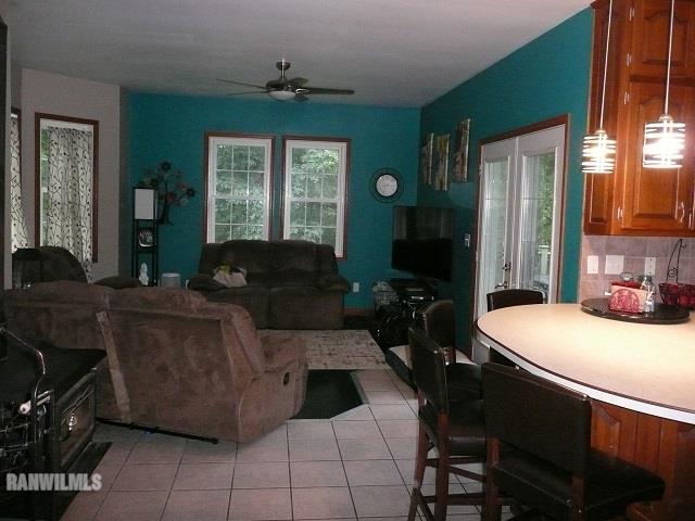 6570 West Cook Road Lena, IL 61048 - Photo 14 of 58 a living room with furniture a large window and a chandelier