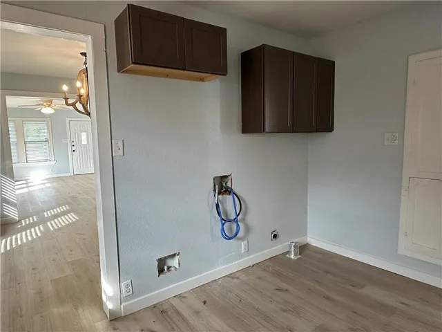 a view of a room with wooden floor and cabinets