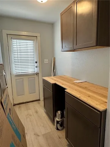 a room with a sink cabinets and utility