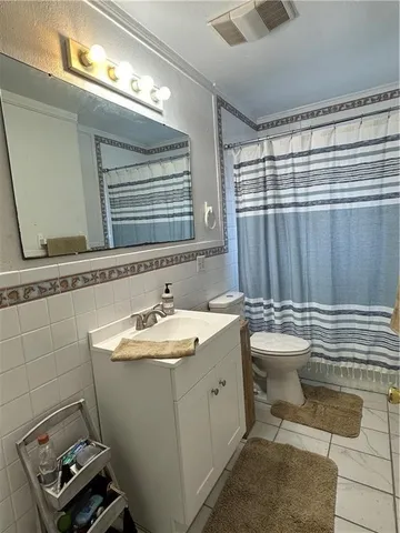 a bathroom with a sink a toilet and tub
