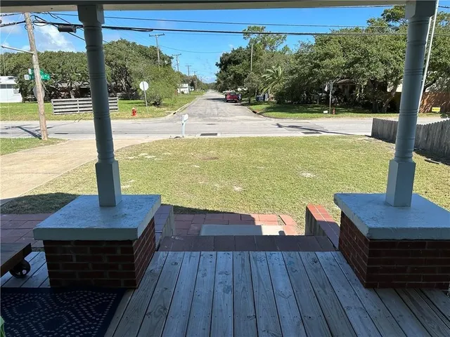 a view of a balcony with wooden floor and outdoor space