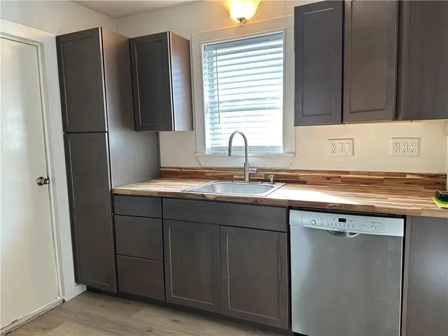 a kitchen with a sink and a refrigerator