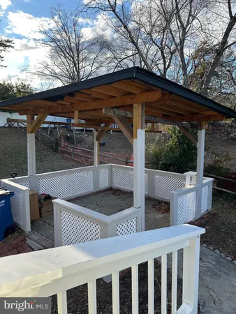 a view of backyard with barbeque grill and wooden fence