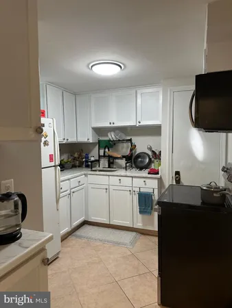 a kitchen with kitchen island granite countertop a sink dishwasher stove top oven and cabinets