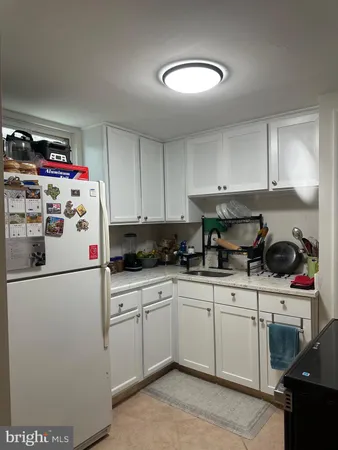 a white refrigerator freezer sitting inside of a kitchen