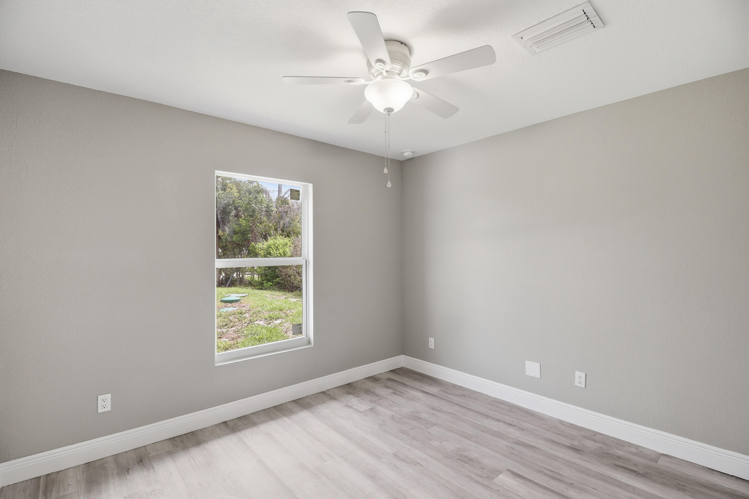 2805 Southeast Carroll Street Stuart, FL 34997 - Photo 13 of 21 wooden floor in an empty room with a window