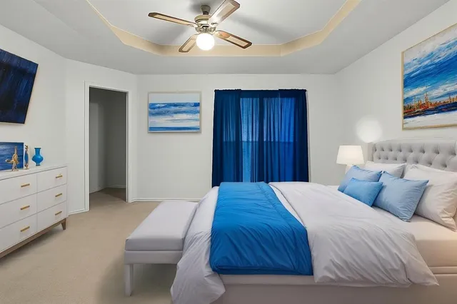 a bedroom with a bed and a wall painting