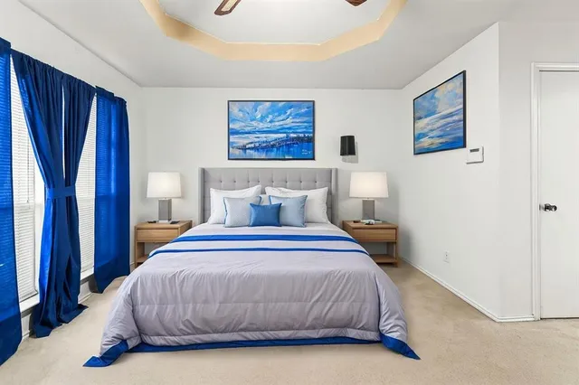 a bedroom with a large bed and a chandelier