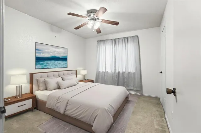 a bedroom with a large bed and a chandelier