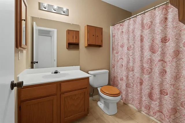 a view of a house with a yard and a tree