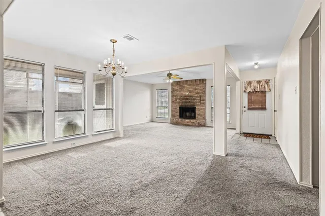 a view of a livingroom with a furniture wooden floor and a chandelier