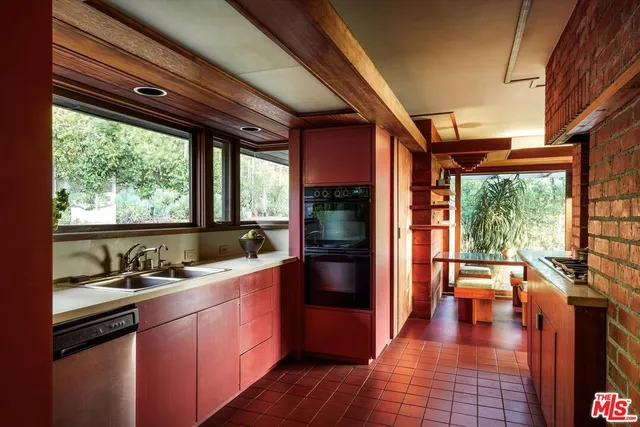 a kitchen with a sink and a large window