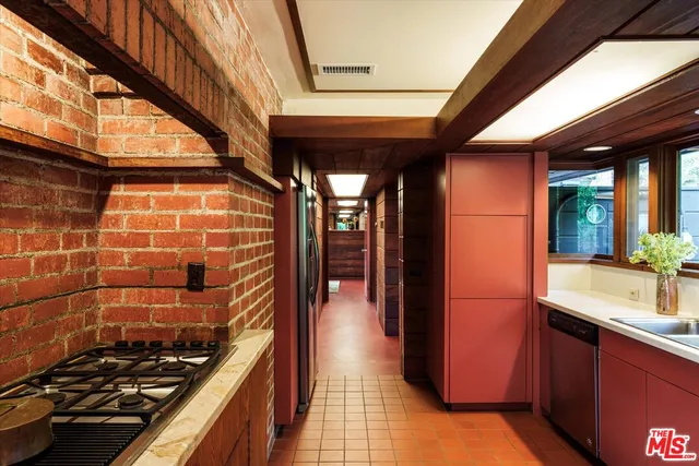 a patio with a table and chairs and a barbeque