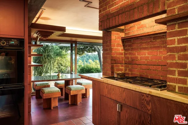 a view of a patio with table and chairs with wooden floor and fence