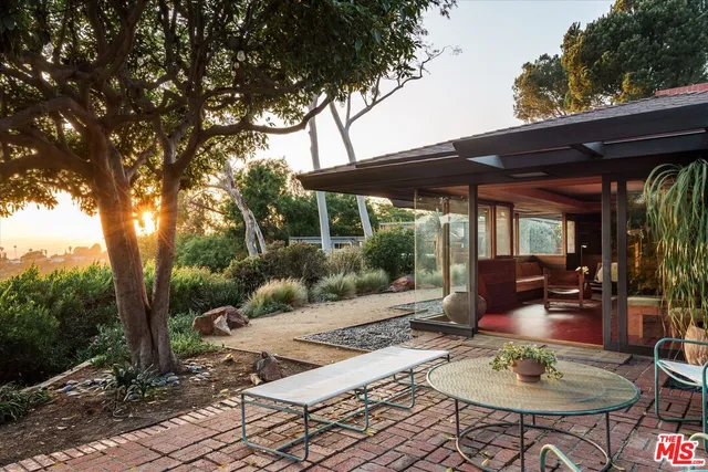 a bedroom with a bed and glass window