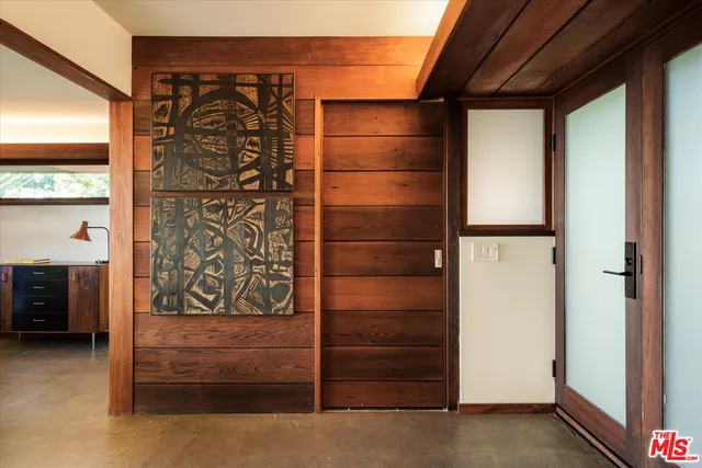 a view of a workspace with furniture and floor to ceiling window