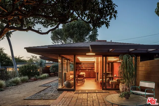 a bed sitting in a balcony next to a window